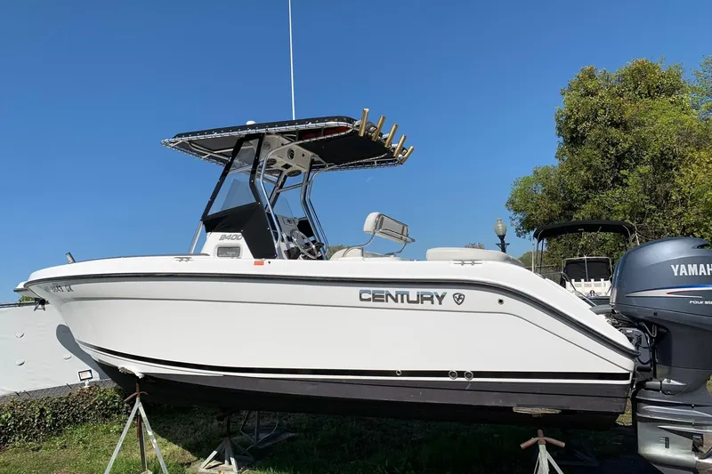 Slide: The Image of 2008 Century 2400 Center Console boat with Yamaha engine, displayed outdoors on stands. - 17