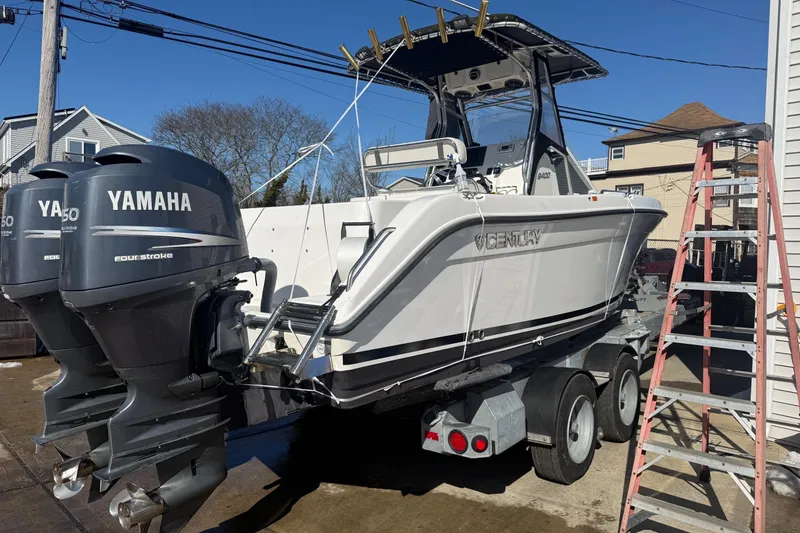 Slide: The Image of 2008 Century 2400 Center Console boat with dual Yamaha engines on a trailer. - 20