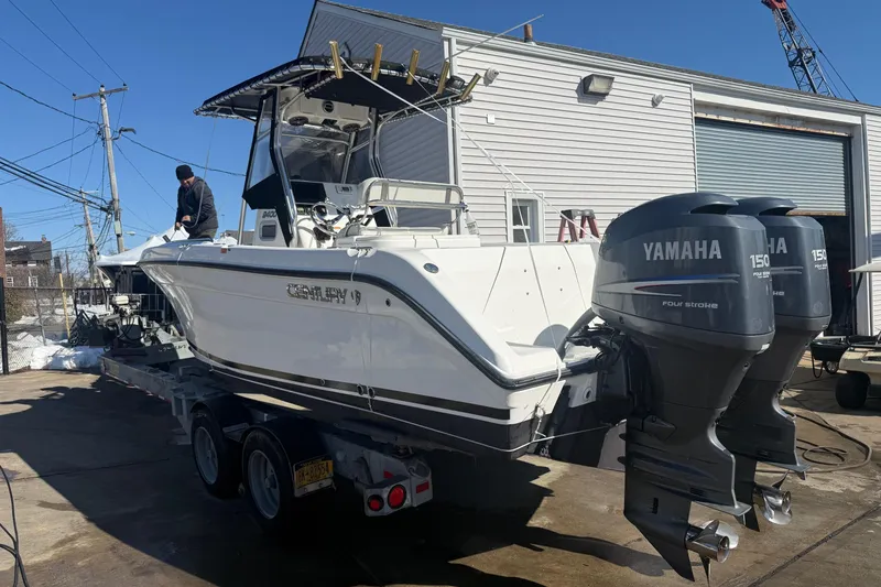 Slide: The Image of 2008 Century 2400 Center Console boat with twin Yamaha 150 engines on a trailer. - 21