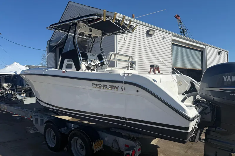 Slide: The Image of 2008 Century 2400 Center Console boat on trailer, parked near a building. - 22