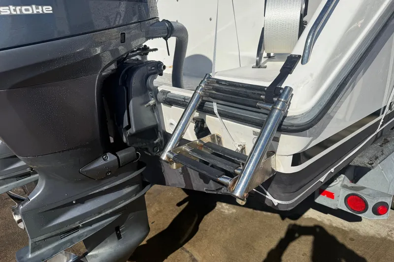 Slide: The Image of 2008 Century 2400 Center Console boat with outboard motor and stainless steel ladder. - 23