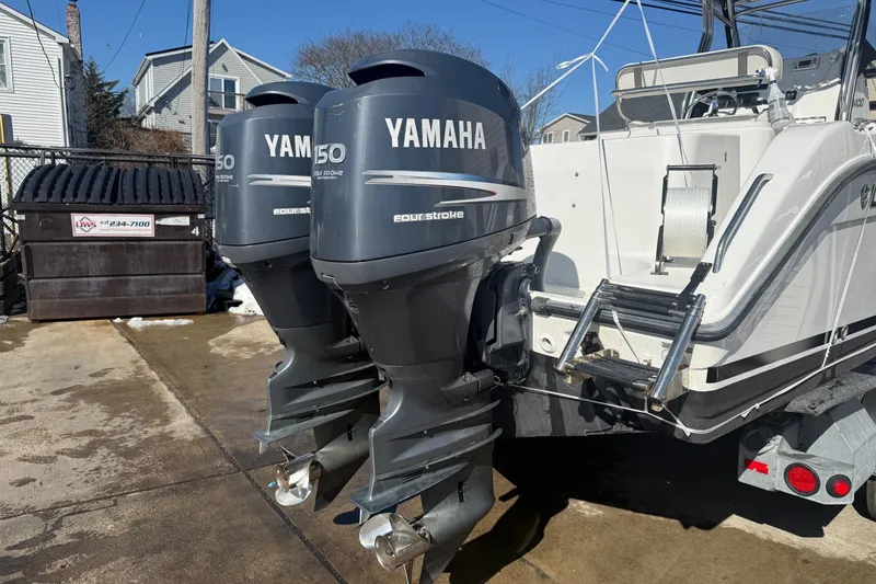 Slide: The Image of Twin Yamaha 150 outboard engines on a 2008 Century 2400 Center Console boat. - 24