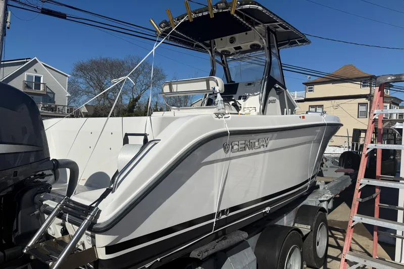 Slide: The Image of 2008 Century 2400 Center Console boat on trailer, outdoor setting, clear sky. - 25