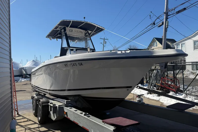 Slide: The Image of 2008 Century 2400 Center Console boat on trailer in sunny marina setting. - 26