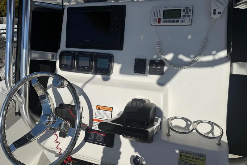 Slide: The Image of 2008 Century 2400 Center Console boat dashboard with steering wheel and navigation equipment. - 29