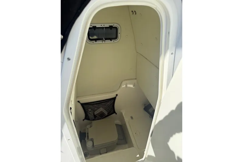 Slide: The Image of 2008 Century 2400 Center Console boat interior cabin with storage and window. - 36