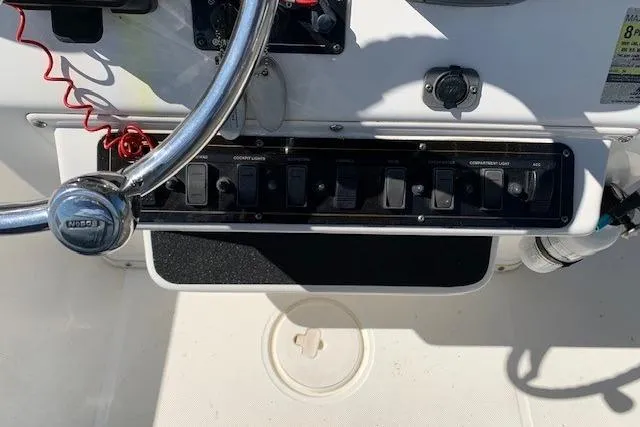 Slide: The Image of 2008 Century 2400 Center Console boat dashboard with steering wheel and control panel. - 38