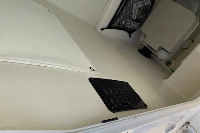 Slide: The Image of Interior view of a 2008 Century 2400 Center Console boat, featuring storage and seating area. - 39