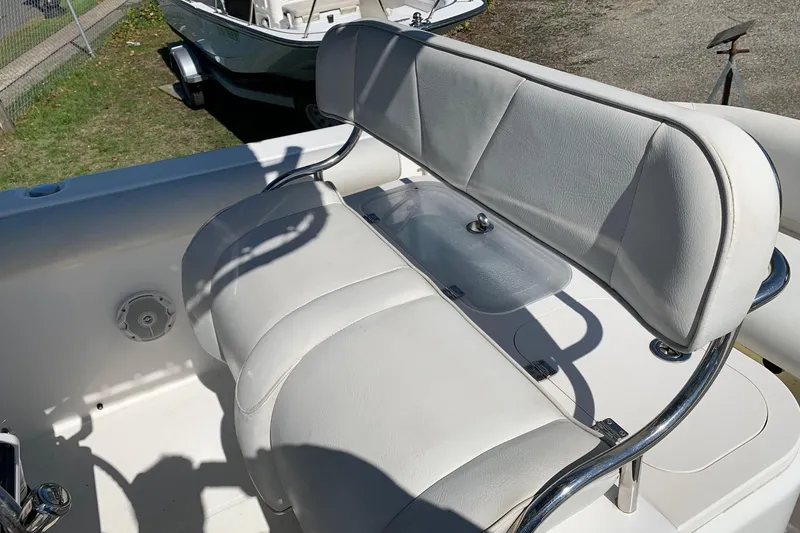 Slide: The Image of 2008 Century 2400 Center Console boat with white cushioned seating and stainless steel frame. - 7