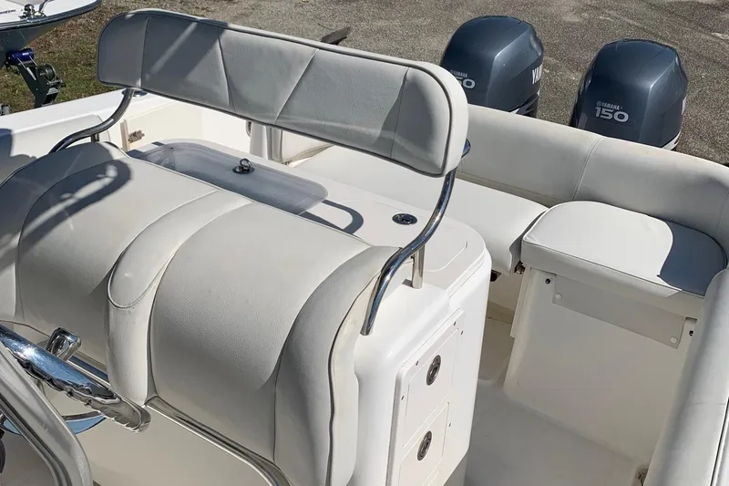 Slide: The Image of 2008 Century 2400 Center Console boat interior with Yamaha 150 engines, featuring cushioned seating. - 9