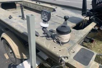 Slide: The Image of 2017 Tracker Grizzly 1548 MVX Sportsman boat with camo design and fishing equipment. - 4