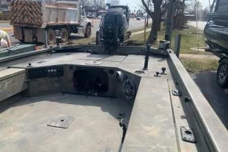 Slide: The Image of 2017 Tracker Grizzly 1548 MVX Sportsman boat, camo interior, parked outdoors. - 5