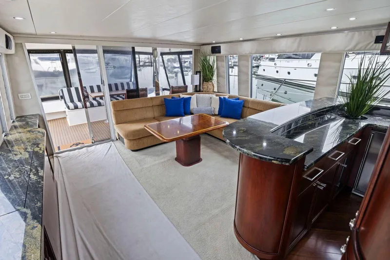 Slide: The Image of Luxurious interior of a 1998 Pacific Mariner 65 yacht with elegant seating and modern decor. - 13