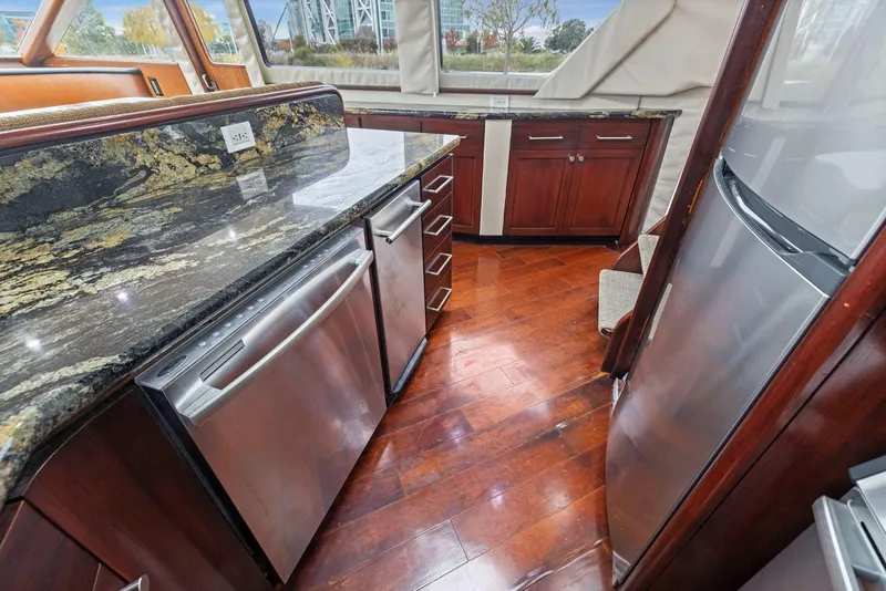 Slide: The Image of Luxurious kitchen in 1998 Pacific Mariner 65 yacht with granite countertops and stainless steel appliances. - 18