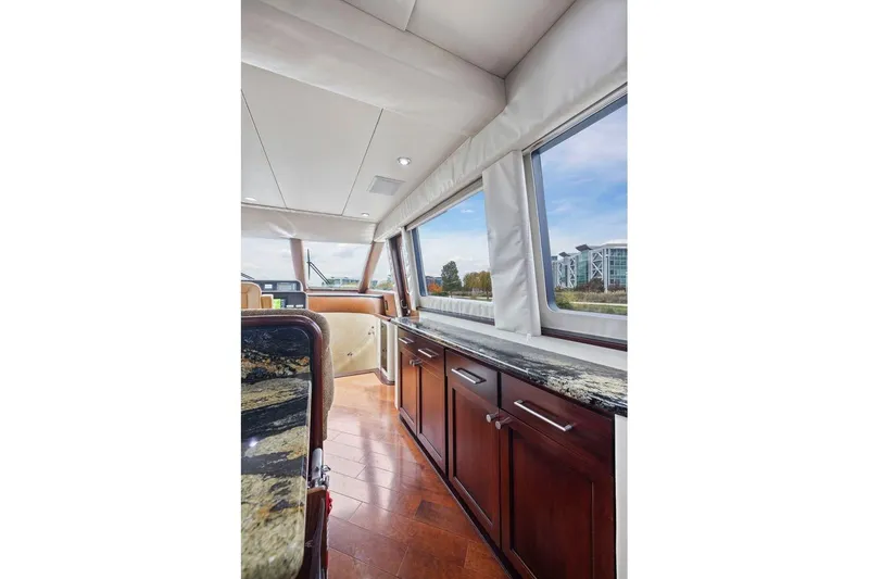 Slide: The Image of Luxurious interior of 1998 Pacific Mariner 65 yacht with elegant wood cabinetry and large windows. - 20