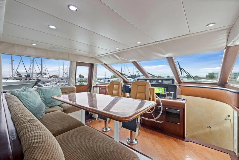 Slide: The Image of Luxurious interior of a 1998 Pacific Mariner 65 yacht with plush seating and helm. - 21