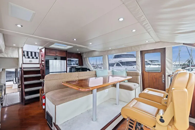 Slide: The Image of Luxurious interior of a 1998 Pacific Mariner 65 yacht with elegant seating and dining area. - 24