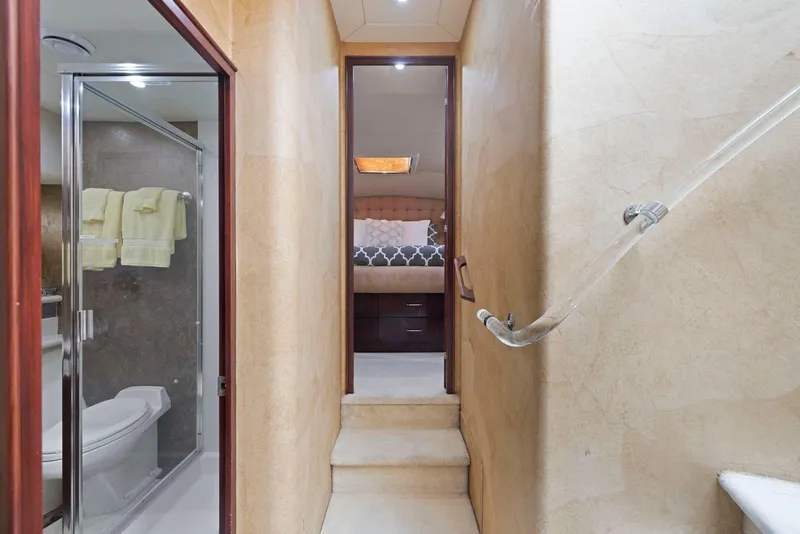Slide: The Image of Luxurious interior of a 1998 Pacific Mariner 65 yacht, featuring a bathroom and bedroom. - 29