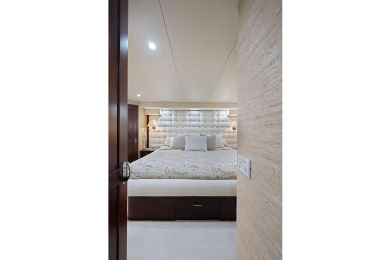 Slide: The Image of Luxurious bedroom interior on a 1998 Pacific Mariner 65 yacht, featuring elegant decor and plush bedding. - 32