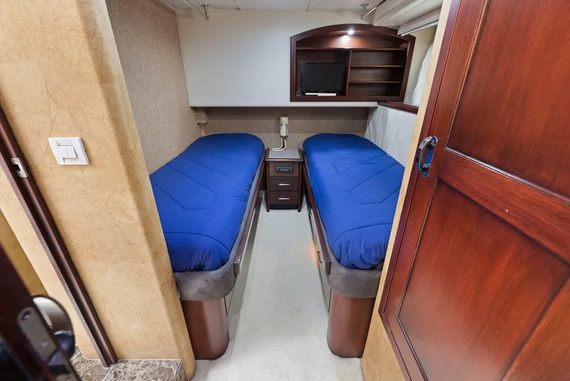 Slide: The Image of Twin cabin with blue bedding in 1998 Pacific Mariner 65 yacht interior. - 43