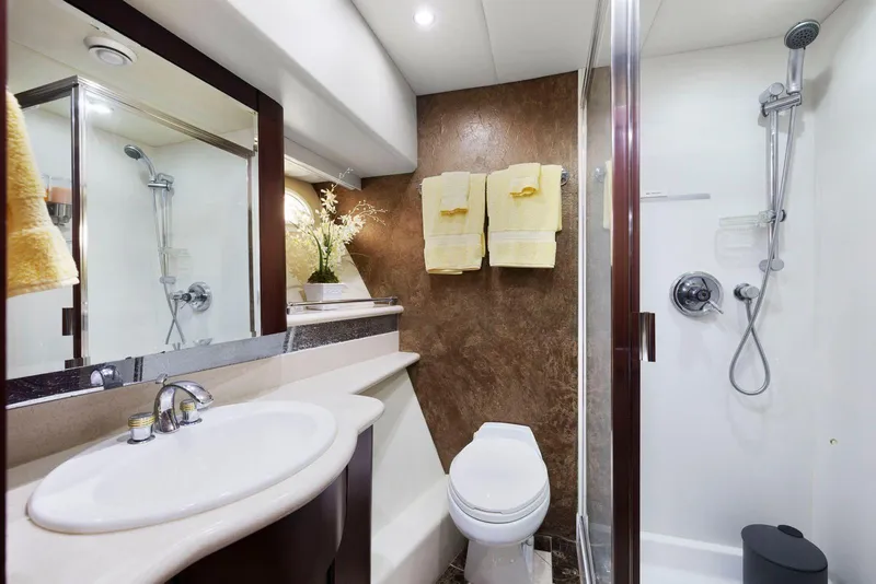 Slide: The Image of Luxurious bathroom in 1998 Pacific Mariner 65 yacht with shower, sink, and elegant decor. - 45