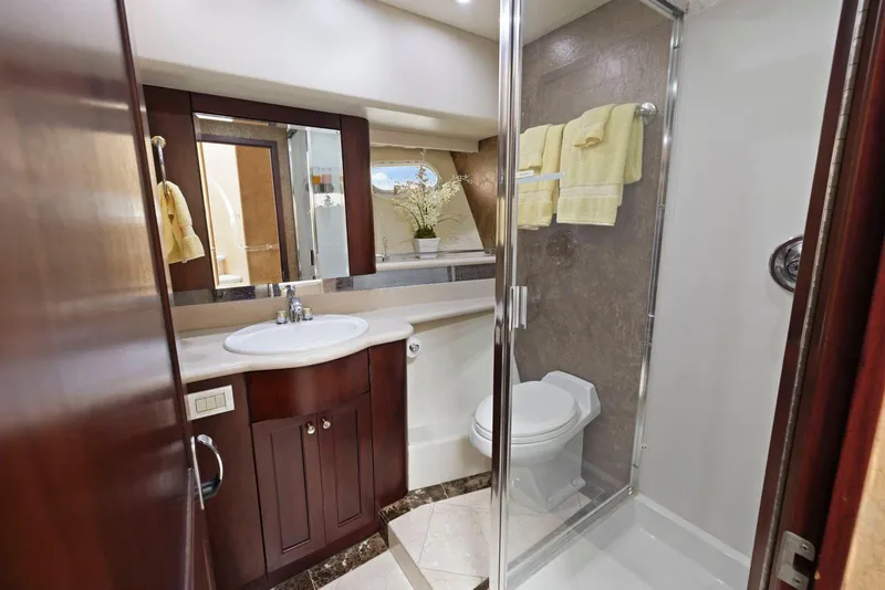 Slide: The Image of Luxurious bathroom in 1998 Pacific Mariner 65 yacht with elegant wood cabinetry and glass shower. - 46