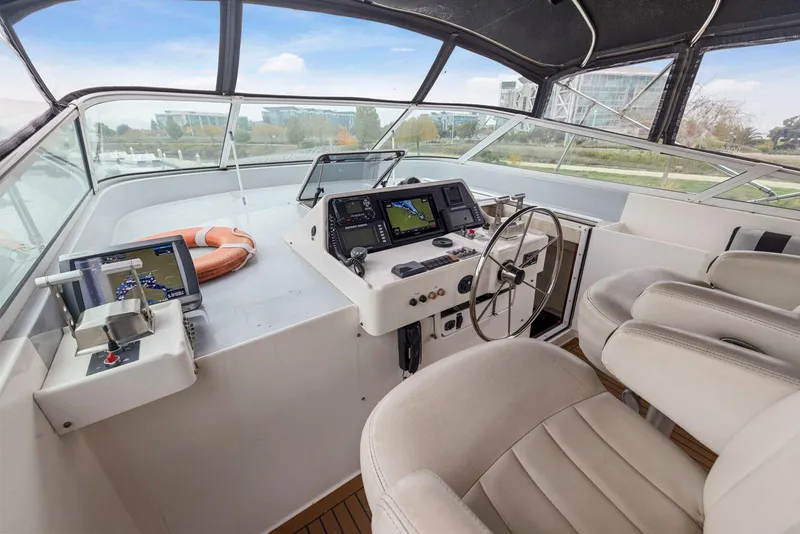 Slide: The Image of Cockpit of 1998 Pacific Mariner 65 yacht with navigation equipment and steering wheel. - 48