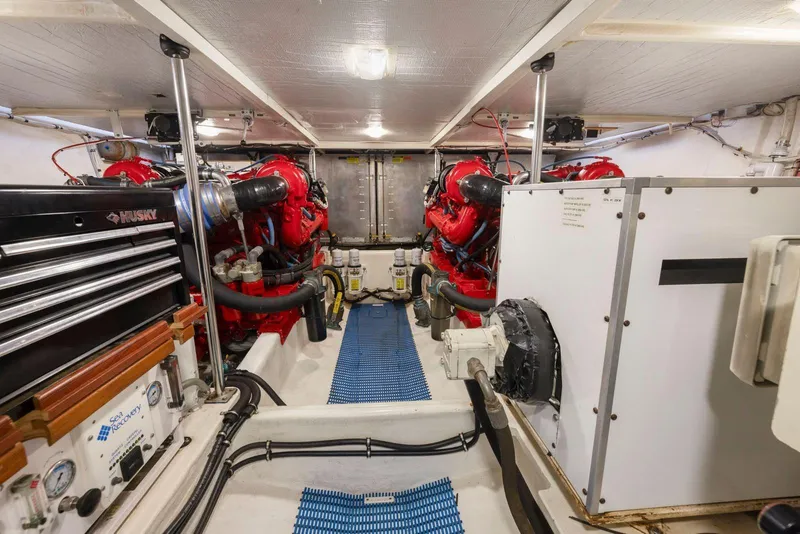 Slide: The Image of Engine room of a 1998 Pacific Mariner 65 yacht with red engines and equipment. - 60