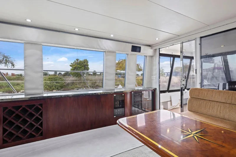 Slide: The Image of Luxurious interior of 1998 Pacific Mariner 65 yacht with elegant wood finishes and scenic views. - 9