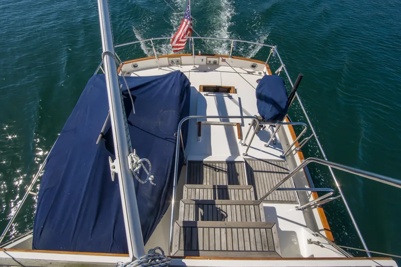 Slide: The Image of Grand Banks 42 Classic yacht deck, 1995 model, cruising on clear blue water. - 12