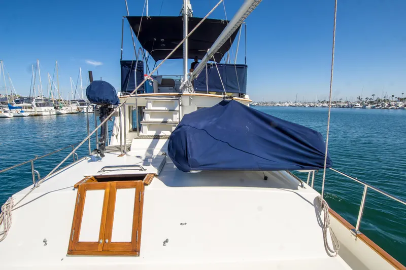 Slide: The Image of 1995 Grand Banks 42 Classic yacht docked in a marina under clear blue skies. - 13