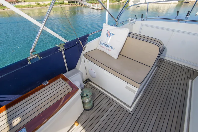 Slide: The Image of 1995 Grand Banks 42 Classic yacht deck with cushioned seating and scenic water view. - 14