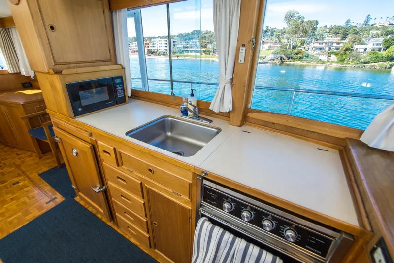 Slide: The Image of Interior of 1995 Grand Banks 42 Classic yacht kitchen with sink, stove, and microwave. - 22