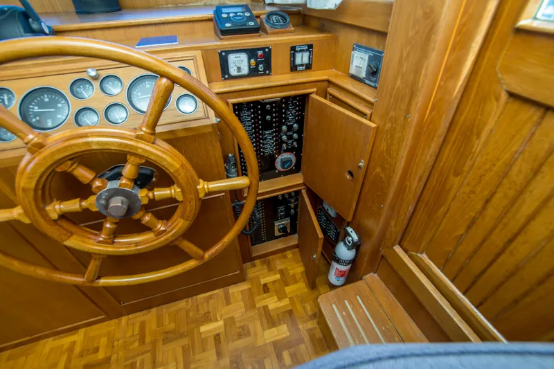 Slide: The Image of Wooden helm and control panel of 1995 Grand Banks 42 Classic yacht. - 23