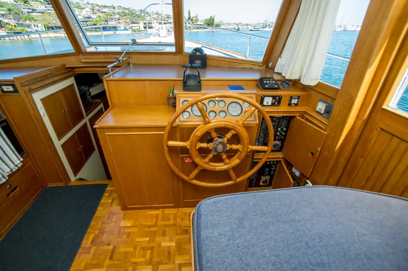 Slide: The Image of Helm of 1995 Grand Banks 42 Classic yacht with wooden steering wheel and control panel. - 24
