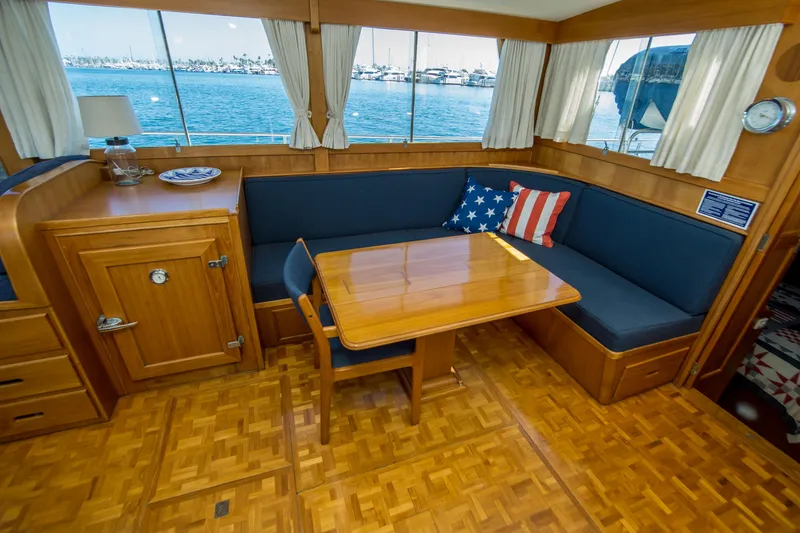 Slide: The Image of Interior of 1995 Grand Banks 42 Classic yacht with wooden dining area and nautical decor. - 25
