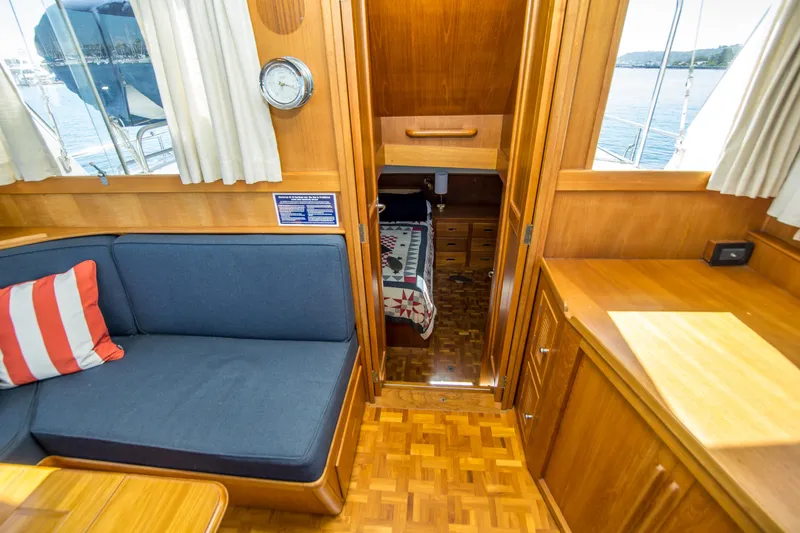 Slide: The Image of Interior of 1995 Grand Banks 42 Classic yacht with cozy seating and wooden cabinetry. - 27