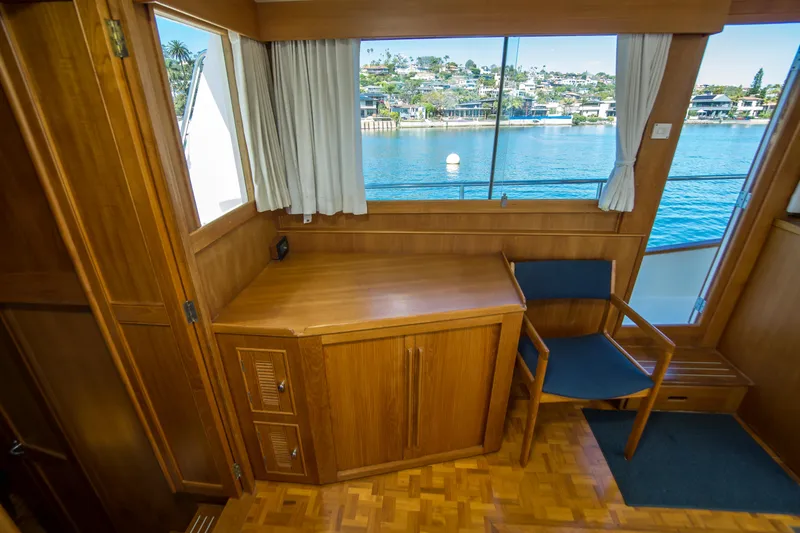 Slide: The Image of Interior of 1995 Grand Banks 42 Classic yacht with wooden desk and chair, overlooking water. - 29