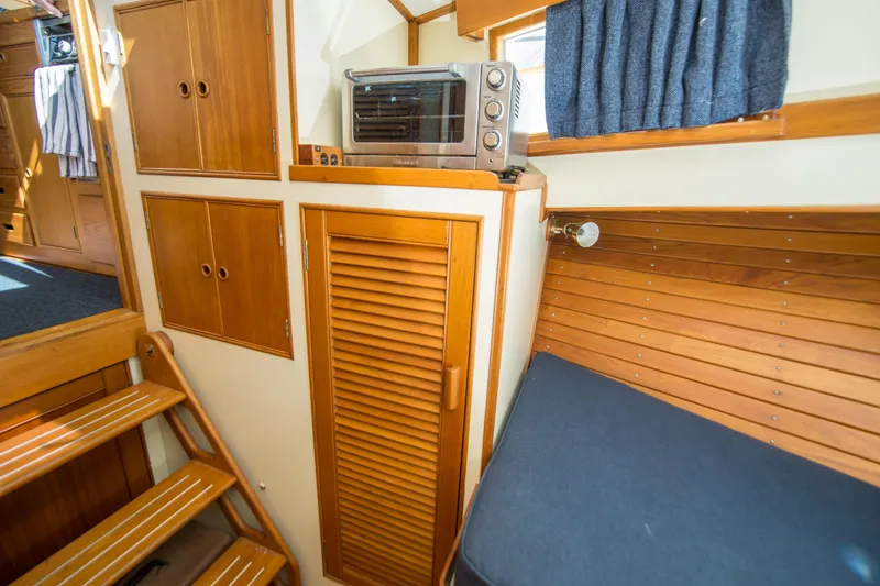 Slide: The Image of Interior of 1995 Grand Banks 42 Classic yacht with wooden cabinetry and seating. - 31