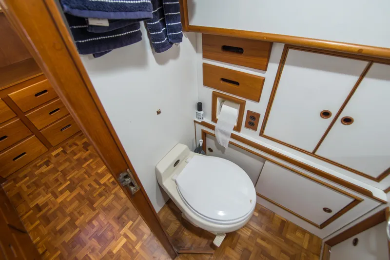 Slide: The Image of Bathroom interior of 1995 Grand Banks 42 Classic yacht with wooden cabinetry and parquet flooring. - 33