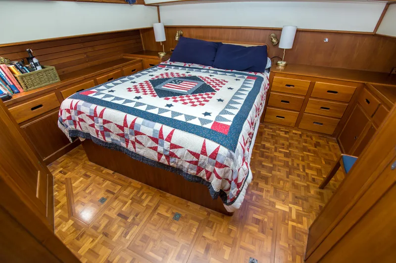 Slide: The Image of Cozy bedroom in 1995 Grand Banks 42 Classic yacht with quilted bedspread and wooden cabinetry. - 35