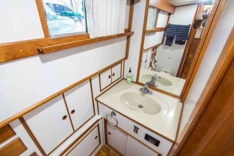Slide: The Image of Bathroom interior of 1995 Grand Banks 42 Classic yacht with wooden accents and sink. - 36