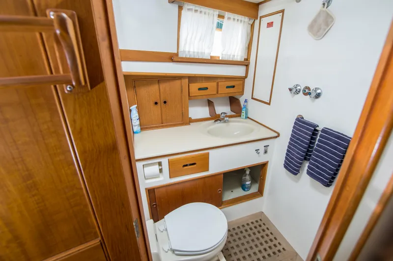 Slide: The Image of Bathroom interior of 1995 Grand Banks 42 Classic yacht, featuring wood cabinetry and nautical decor. - 37