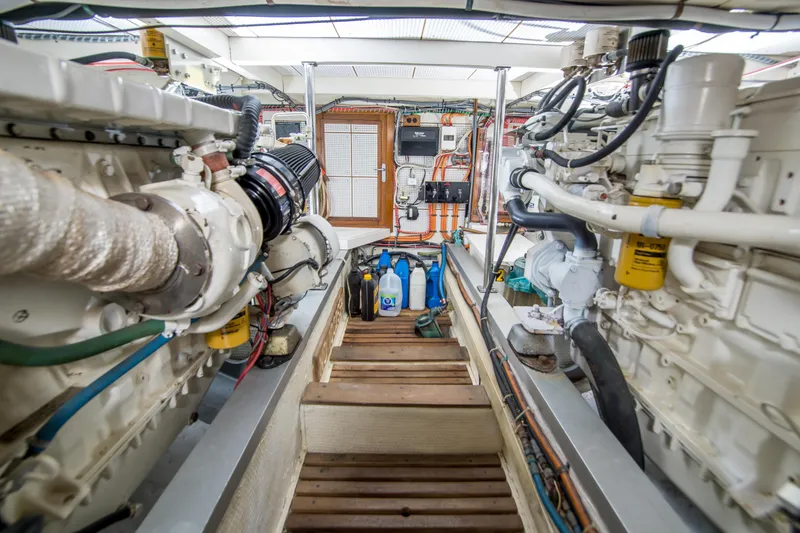 Slide: The Image of Engine room of a 1995 Grand Banks 42 Classic yacht, showcasing dual engines and equipment. - 38