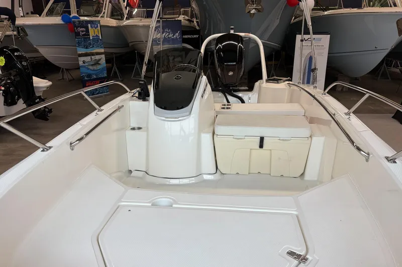 Slide: The Image of 2025 Boston Whaler 160 Super Sport boat interior with seating and console. - 3