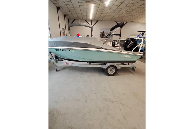 Slide: The Image of 2025 Boston Whaler 160 Super Sport boat on trailer in showroom. - 4