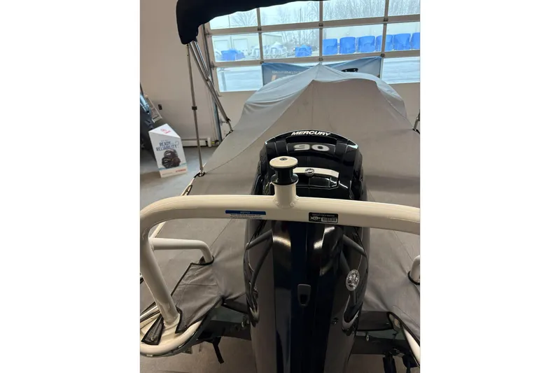 Slide: The Image of 2025 Boston Whaler 160 Super Sport with Mercury 90 engine, covered in a garage. - 8