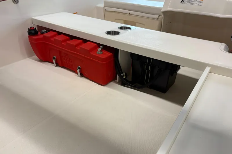 Slide: The Image of 2025 Boston Whaler 160 Super Sport interior with red fuel tank and storage compartment. - 9