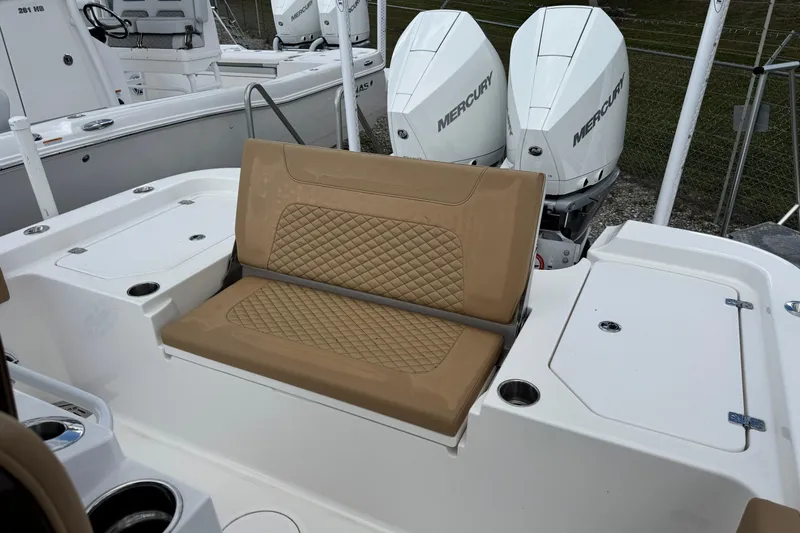 Slide: The Image of 2025 Caymas 291 boat with tan seating and dual Mercury outboard engines. - 10