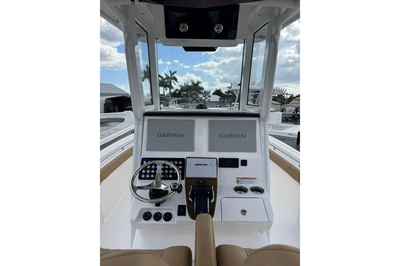 Slide: The Image of 2025 Caymas 291 boat dashboard with Garmin navigation system and Mercury controls. - 5